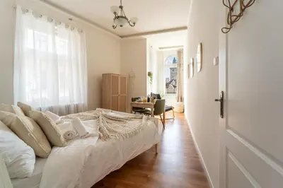 an empty room with a large window and a radiator at Celine Prague Hostel in Prague