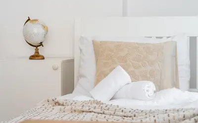 a living room with white furniture and a large window at Celine Prague Hostel in Prague
