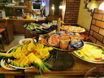 a buffet with many plates of food on a table at River Star Hotel in Prague