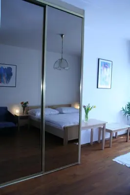 a bedroom with a bed and a glass wall at Pension Filip in Prague