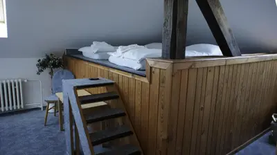 a room with a bed and a ladder next to a room at Pension Filip in Prague