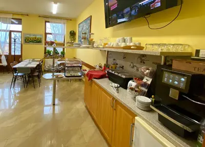a kitchen with a counter and a dining room at Hotel U Radnice in Louny