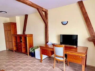 a dining room with tables and chairs in a restaurant at Hotel Na Hradbách in Louny