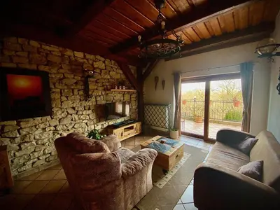 a living room with two couches and a stone fireplace at Hotel Na Hradbách in Louny