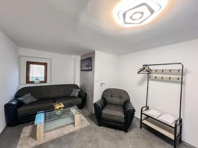 a living room with two couches and a table at Apartmány Pod Řípem in Roudnice nad Labem