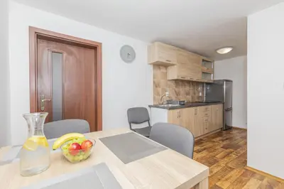a kitchen with a table with a bowl of fruit on it at Apartmány Pod Řípem in Roudnice nad Labem