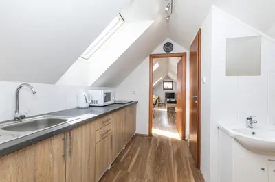 a white kitchen with a sink and a sink at Apartmány Pod Řípem in Roudnice nad Labem