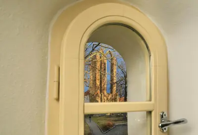 an open door with a stained glass window of a church at Bellevue Hotel Benešov in Benešov
