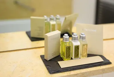 a group of four bottles of oil on a counter at Bellevue Hotel Benešov in Benešov