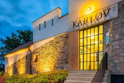a building with a sign that reads karrow at Bellevue Hotel Benešov in Benešov