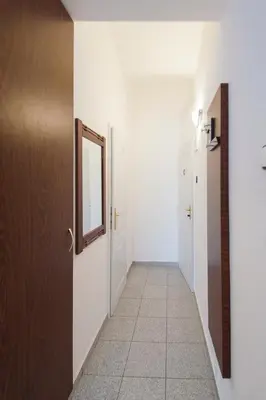 a hallway with a door and a mirror on a wall at Modern Apartment Skolska 20 in Prague