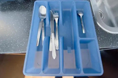 a blue plastic tray with cutlery in it at Modern Apartment Skolska 20 in Prague