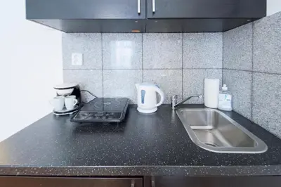 a kitchen with a sink and a counter top at Modern Apartment Skolska 20 in Prague