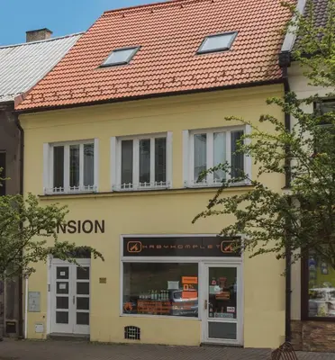 a yellow building with a red roof at Pension U kostela in Český Brod
