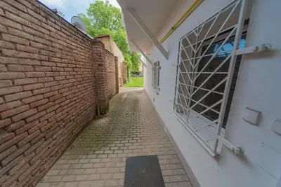 an alley with a brick wall and a window at Pension U kostela in Český Brod