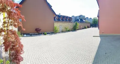 a courtyard of a building with a brick sidewalk at Apartment De Luna in Prague