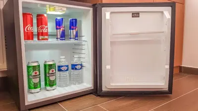 an open refrigerator filled with water and soda at Apartment De Luna in Prague