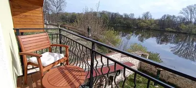 two beds in a room with a table and chairs at Ubytování U Tajčů in Dolní Beřkovice
