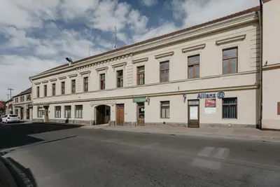 a large white building on the side of a street at Apartmán 3, Suvorovova 158 in Český Brod