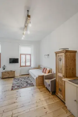 a bedroom with a bed and a couch in a room at Apartmán 3, Suvorovova 158 in Český Brod