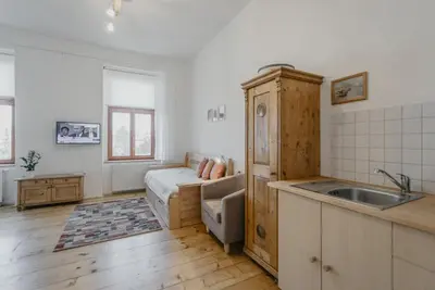 a kitchen with a sink and a bed in a room at Apartmán 3, Suvorovova 158 in Český Brod