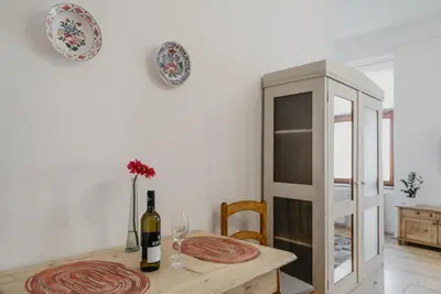 a dining room with a table with a bottle of wine at Apartmán 3, Suvorovova 158 in Český Brod