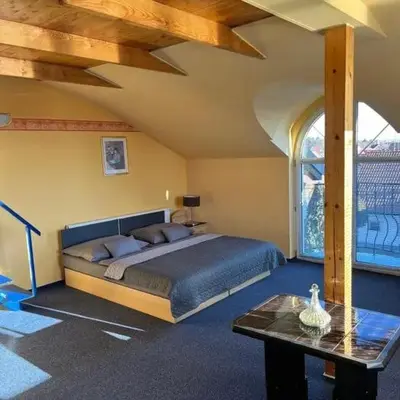 a hotel room with two beds and a couch at Penzion Ariane in Prague