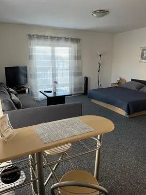 a living room with a couch and a bed at Penzion Ariane in Prague