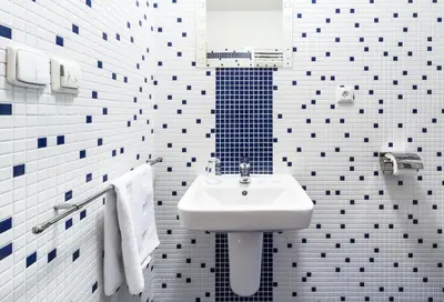 a white bathroom with a sink and a mirror at Penzion Palouček in Prague