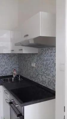 a bedroom with a bed and a large white cabinet at Sekaninova 52 Retro Flat in Prague