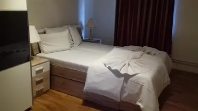 a living room with a table and a couch at Sekaninova 52 Retro Flat in Prague