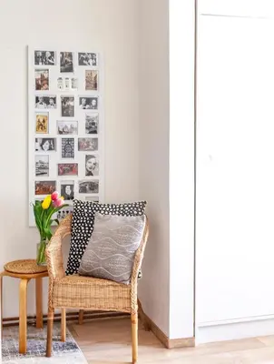 a room with a rattan chair and a vase with flowers at Prague Castle Garden Apartment in Prague