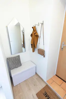 a small bathroom with a mirror and a bench at Prague Castle Garden Apartment in Prague