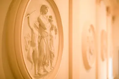 a sculpture of a woman and a man on a wall at Quentin Prague Hotel in Prague