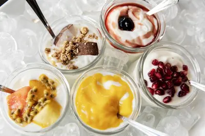 a group of four different desserts in glass bowls at Quentin Prague Hotel in Prague