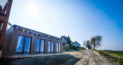 a building with windows on the side of a dirt road at Výhledna in Beroun