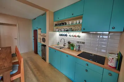 a kitchen with blue cabinets and a sink at Výhledna in Beroun
