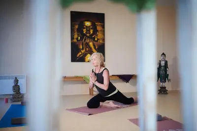 a woman doing yoga in a room with a statue at Výhledna in Beroun