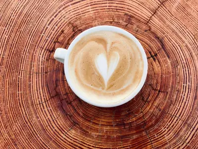 a cup of coffee with a heart painted on it at Výhledna in Beroun