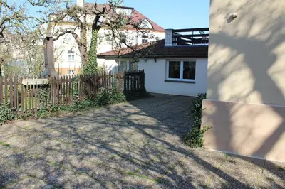 a house with a fence and a driveway at Pension Hanspaulka in Prague