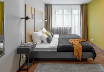 a bedroom with a large bed with a window at City Leaf Apartments in Prague