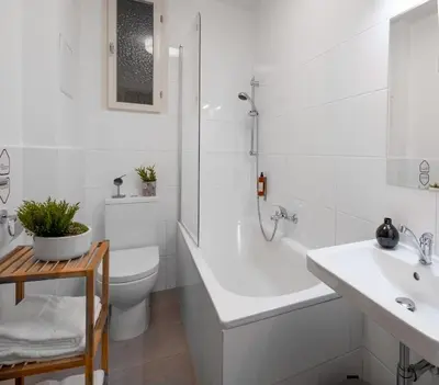a bathroom with a tub and a toilet and a sink at City Leaf Apartments in Prague