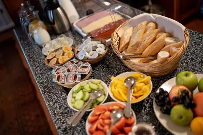 a table with a bunch of different types of food at Hotel Dvur Hoffmeister in Velké Číčovice