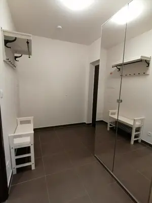 an empty room with a glass wall and a bench at Prima Family Apartments in Prague