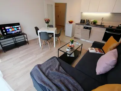 a living room with a couch and a table at Prima Family Apartments in Prague
