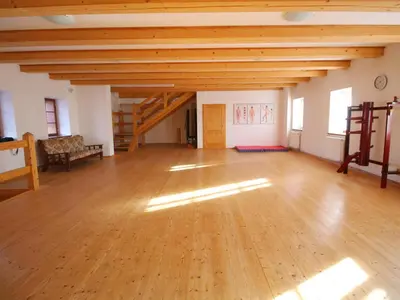 a large room with a wooden floor and wooden ceilings at Žabonosy Mlýn in Žabonosy