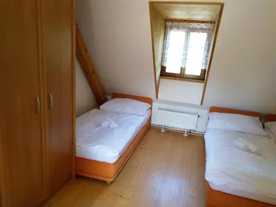 two beds in a small room with a mirror at Žabonosy Mlýn in Žabonosy