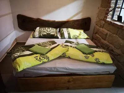 two beds with pillows on them in a room at Green Apartments in Luštěnice