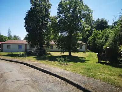 a house sitting on the side of a road at Green Apartments in Luštěnice