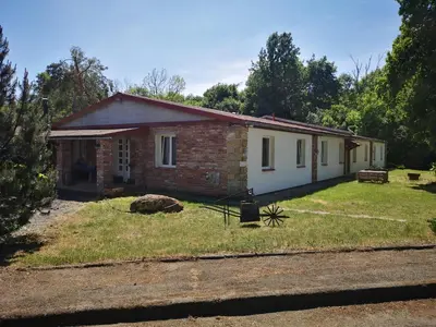 a small brick house in the middle of a yard at Green Apartments in Luštěnice